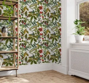 A green, grey, beige and red wallpaper of flowers intertwined with cheeky chameleons. Design available exclusively from Wallpaper Online Canada.