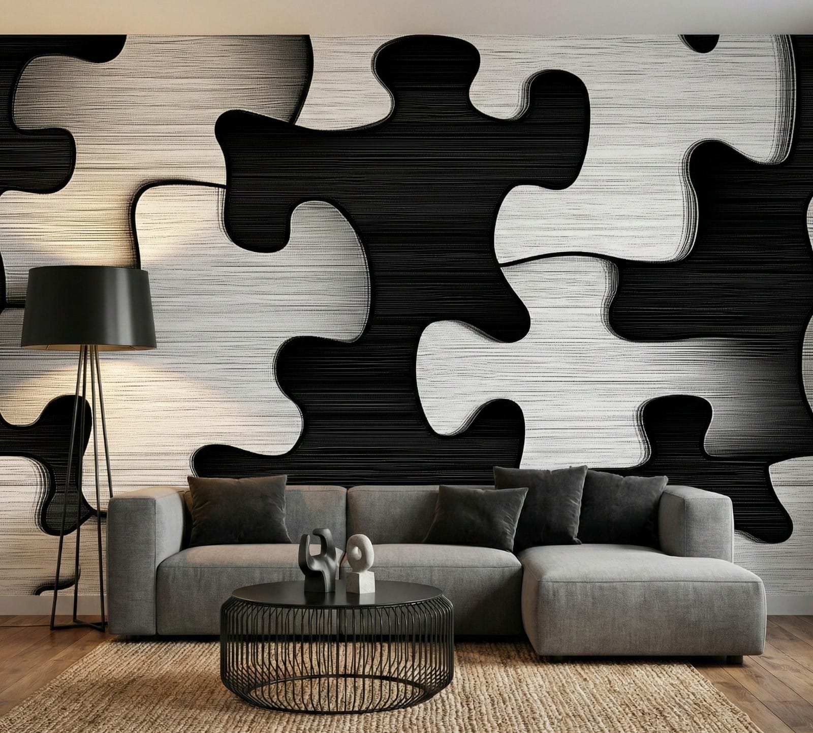 Black and white jigsaw wallpaper with interlocking puzzle shapes, styled behind a grey sectional sofa in a modern living room.