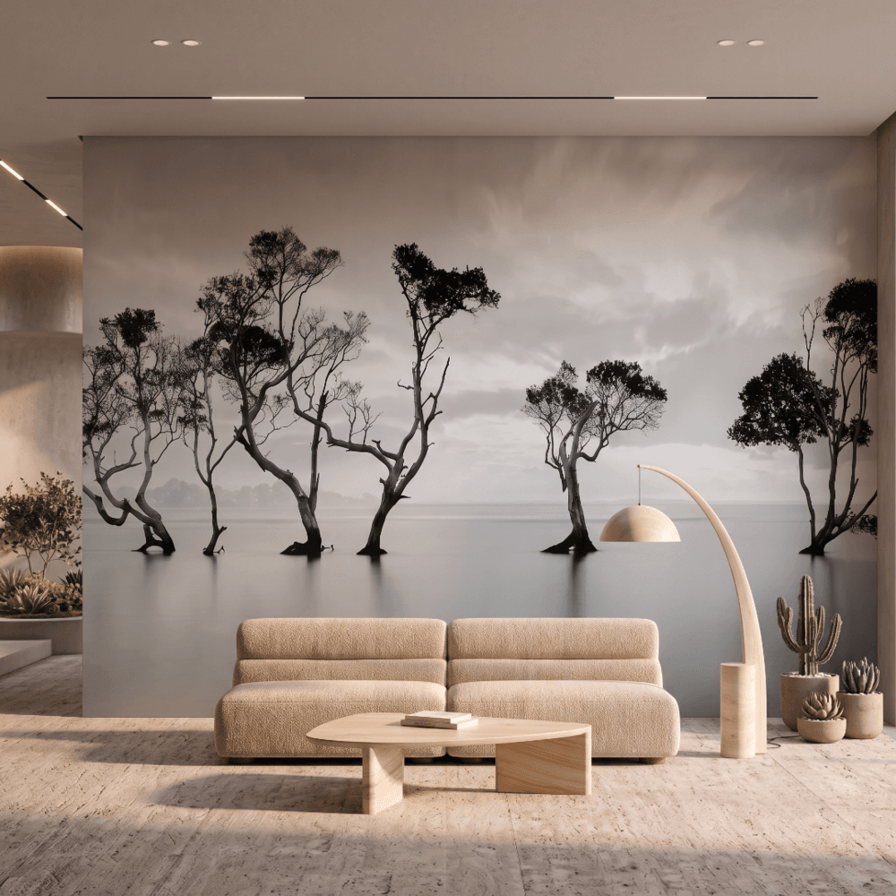 A zoomed-in view of Still Waters Gnarled Trees Mural behind a beige modular sofa and wooden table