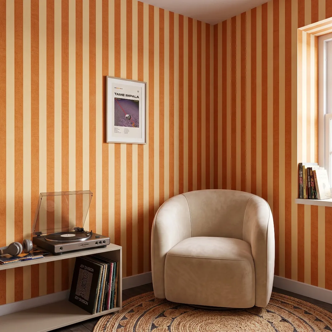 Striped wallpaper in a cozy reading corner.
